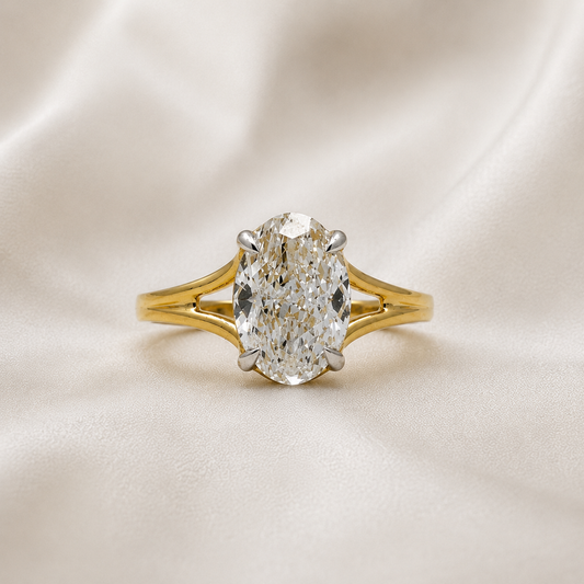 Split shank oval diamond solitaire ring in yellow gold, close-up view
